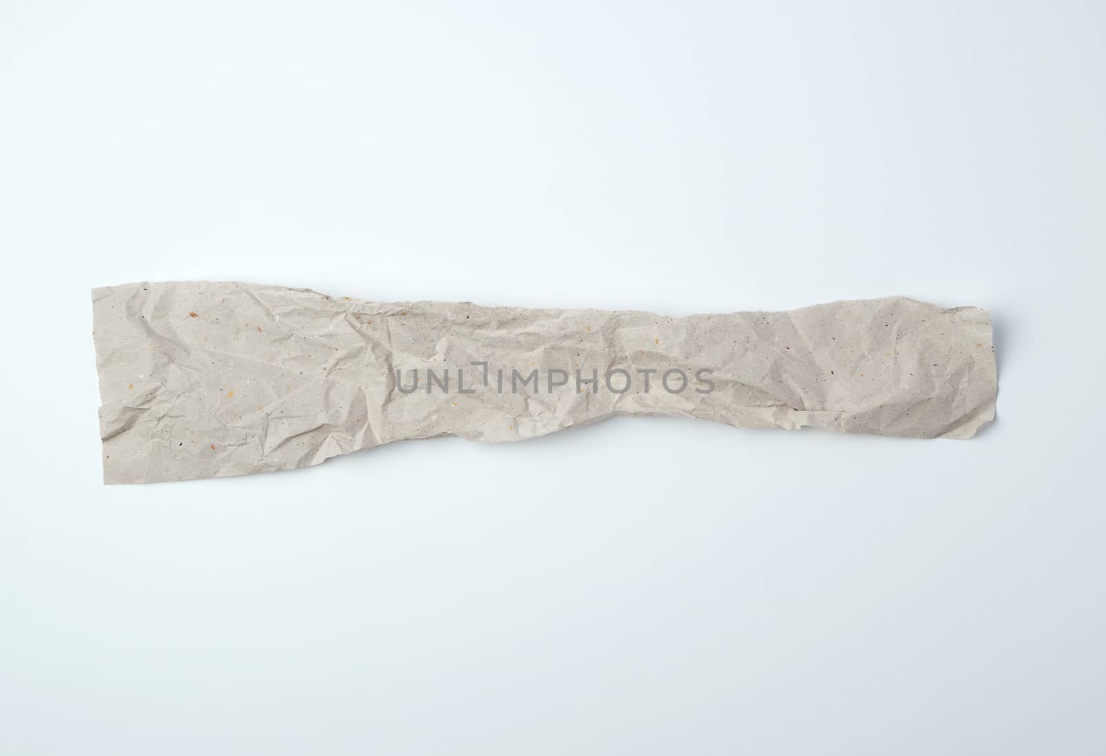 crumpled torn piece of gray paper on a white background, close up