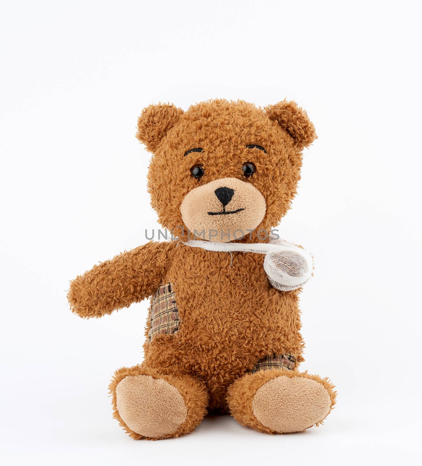 brown teddy bear with rewound white bandage paw on a white backg by ndanko