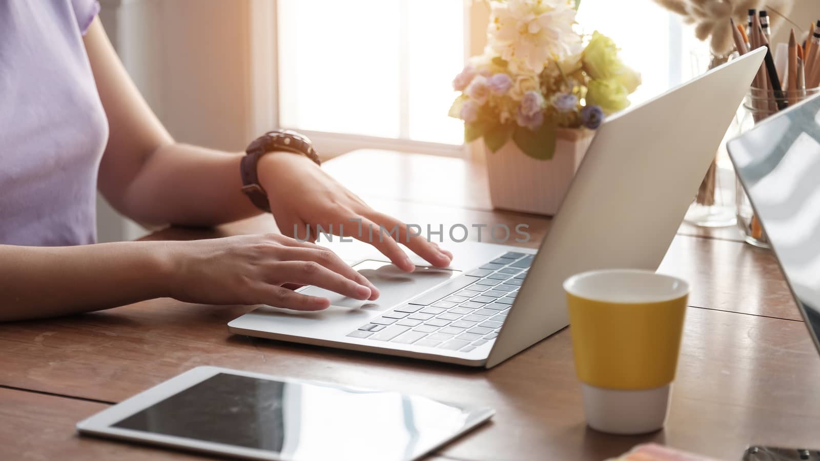 Close up young woman using her laptop at home, freelance, studying, working.