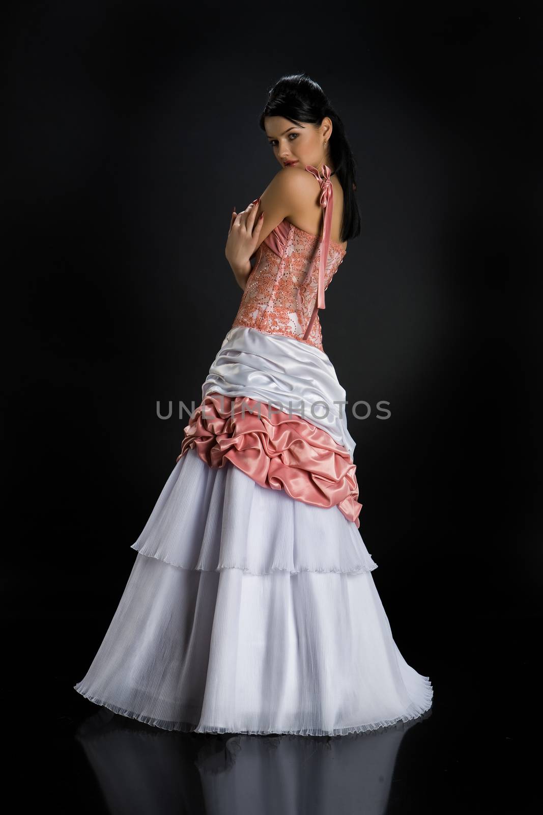 Young beautiful woman in a wedding dress on a studio background