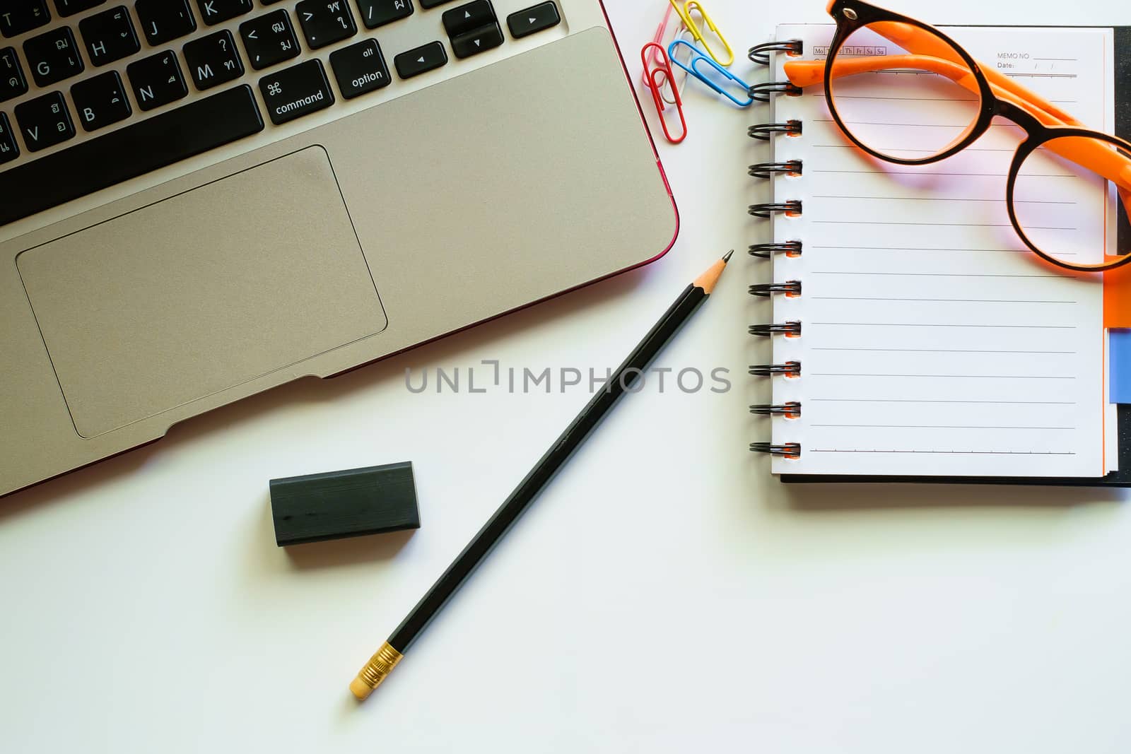 Top view of computer laptop and the other office accessories on the white table workplace