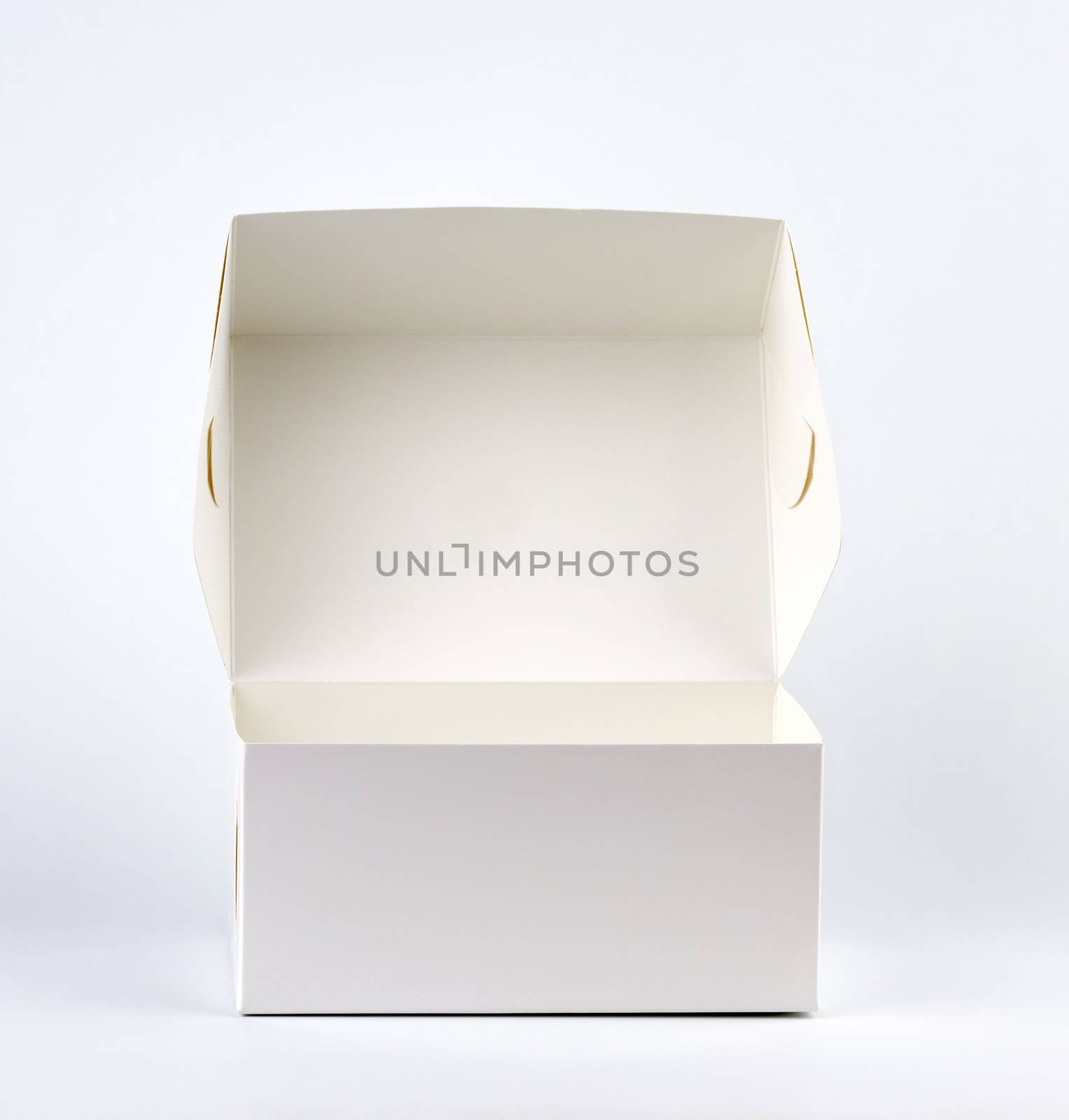 empty open white cardboard box on a white background by ndanko