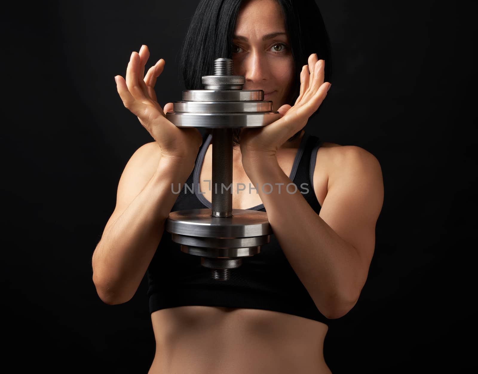 young woman of Caucasian appearance holds steel type-setting dum by ndanko