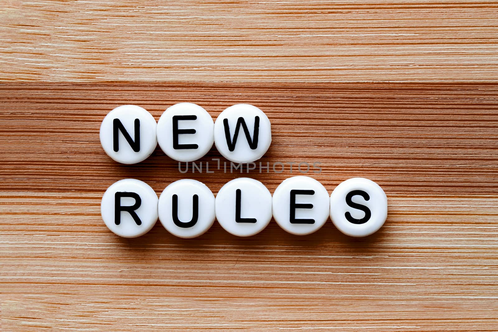 New Rules test on a brown wooden table