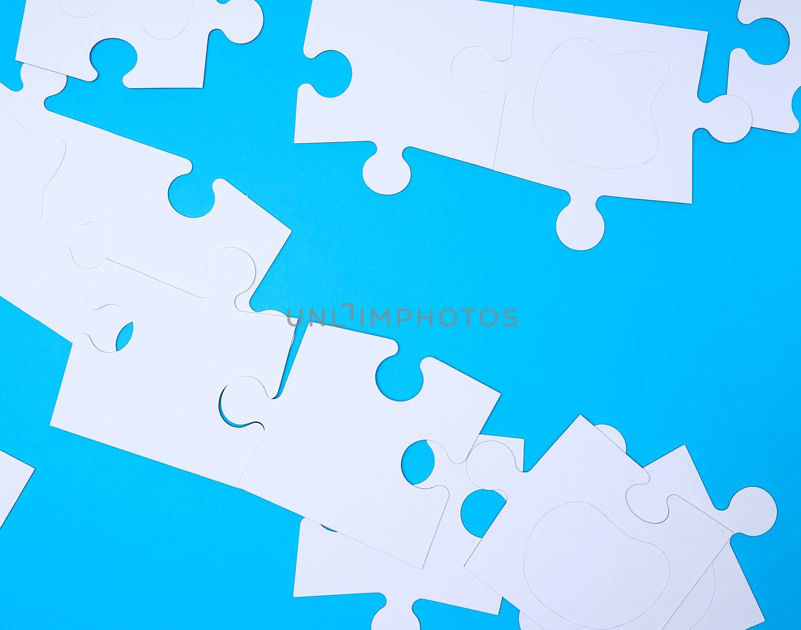 empty white big puzzles on a blue background. Concept in business