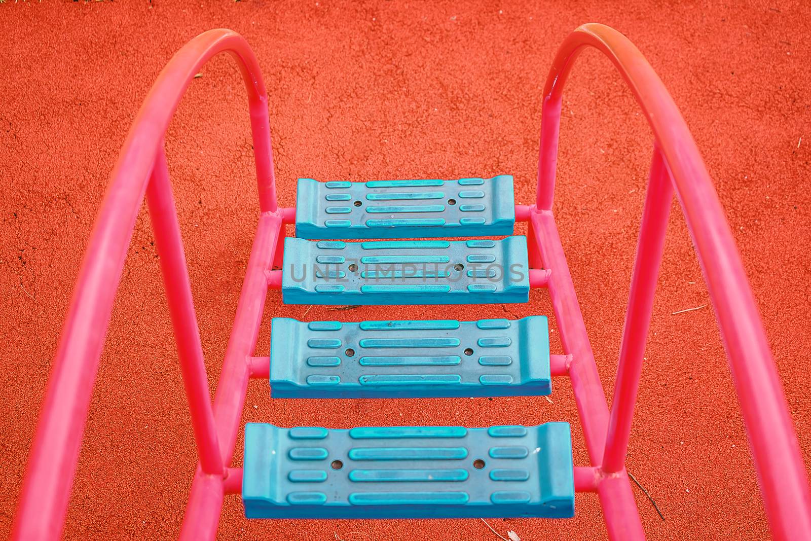 Top view of blue ladder for kids to walk up to playground equipment