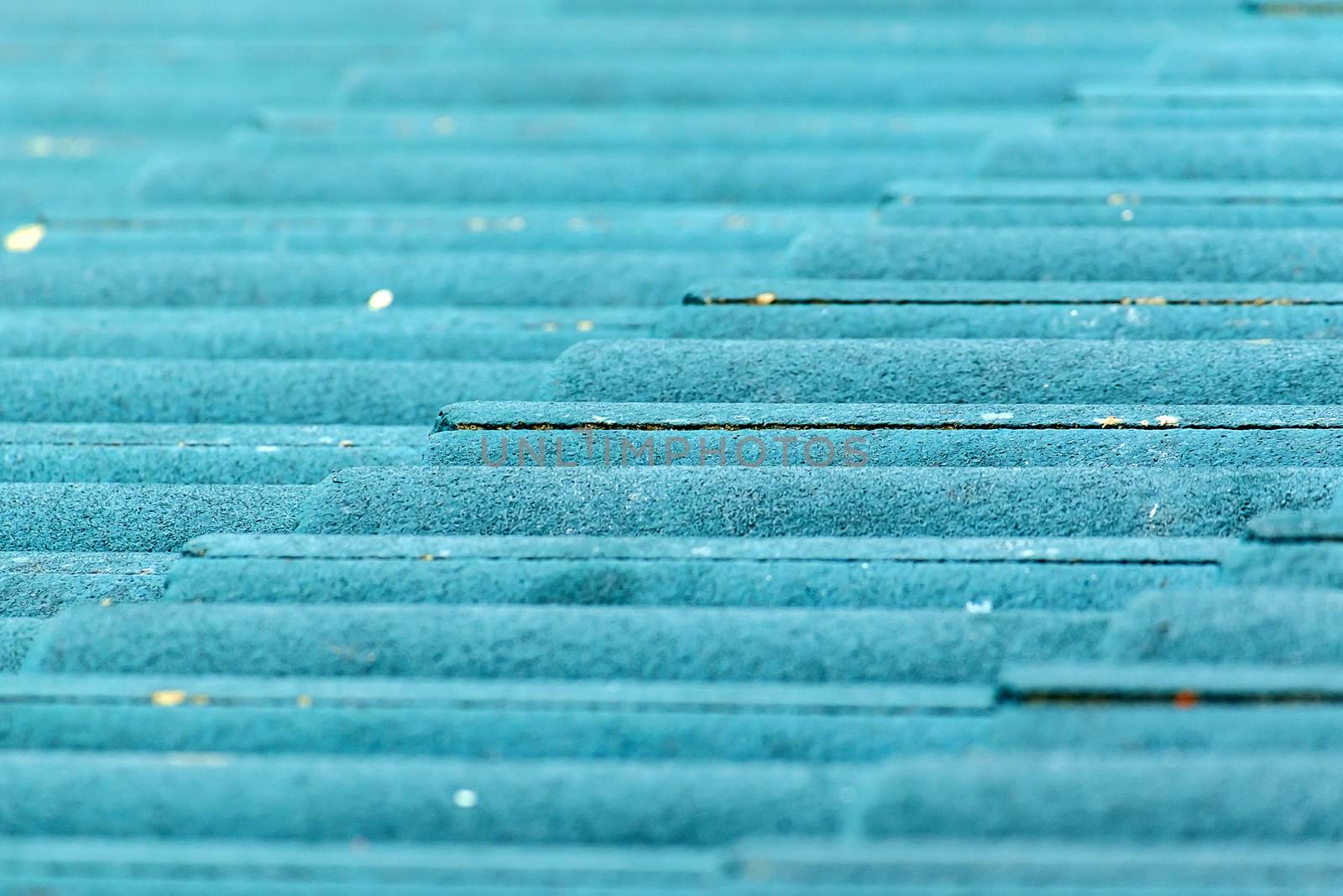 Close up of green concrete roof tile with soft light and shallow DOF