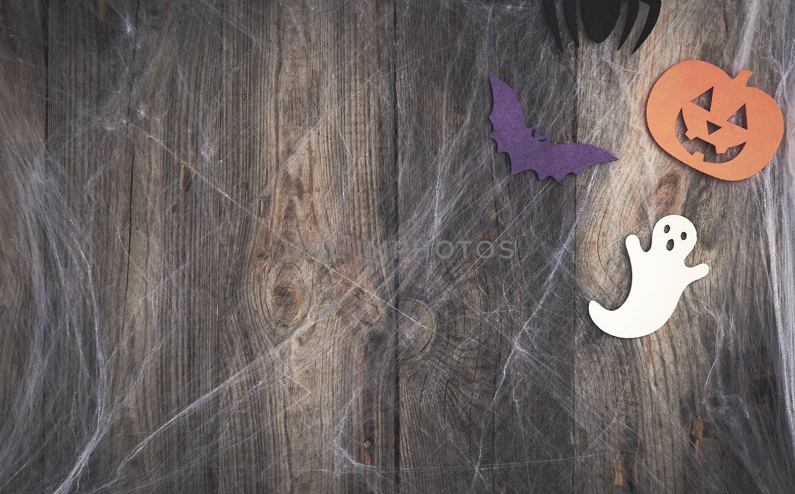 white spider web and carved pumpkin-shaped felt decor, backdrop for Halloween holiday