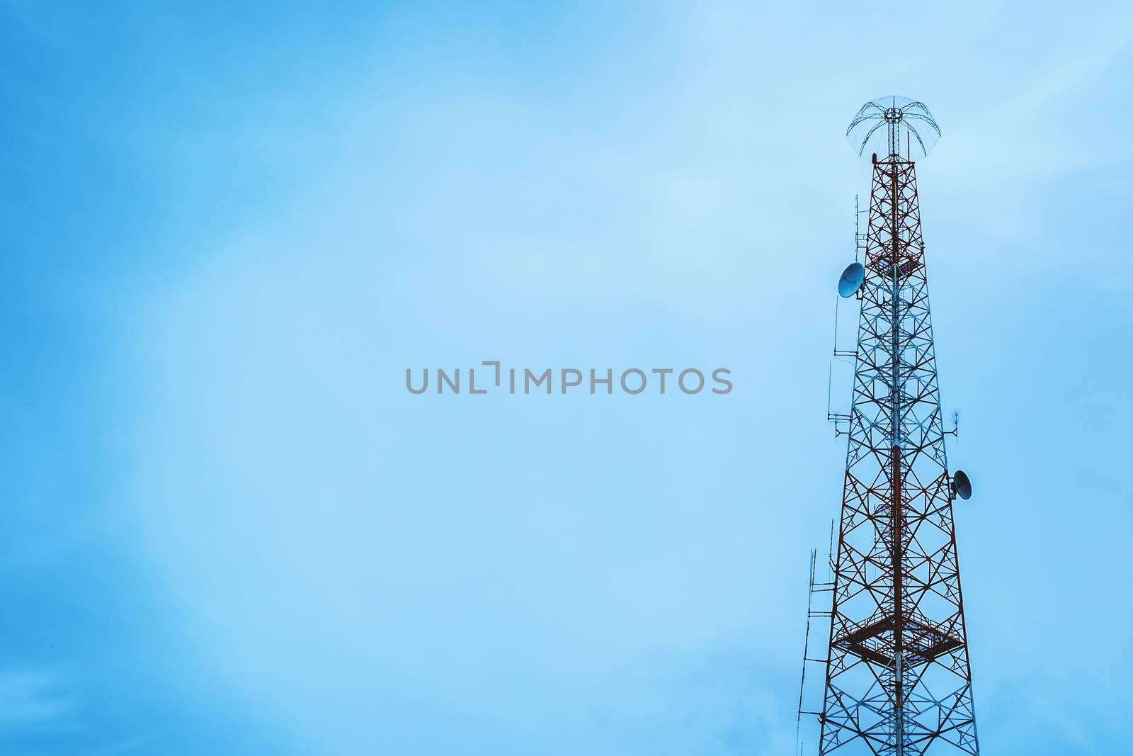 Telecommunication tower against blue sky background