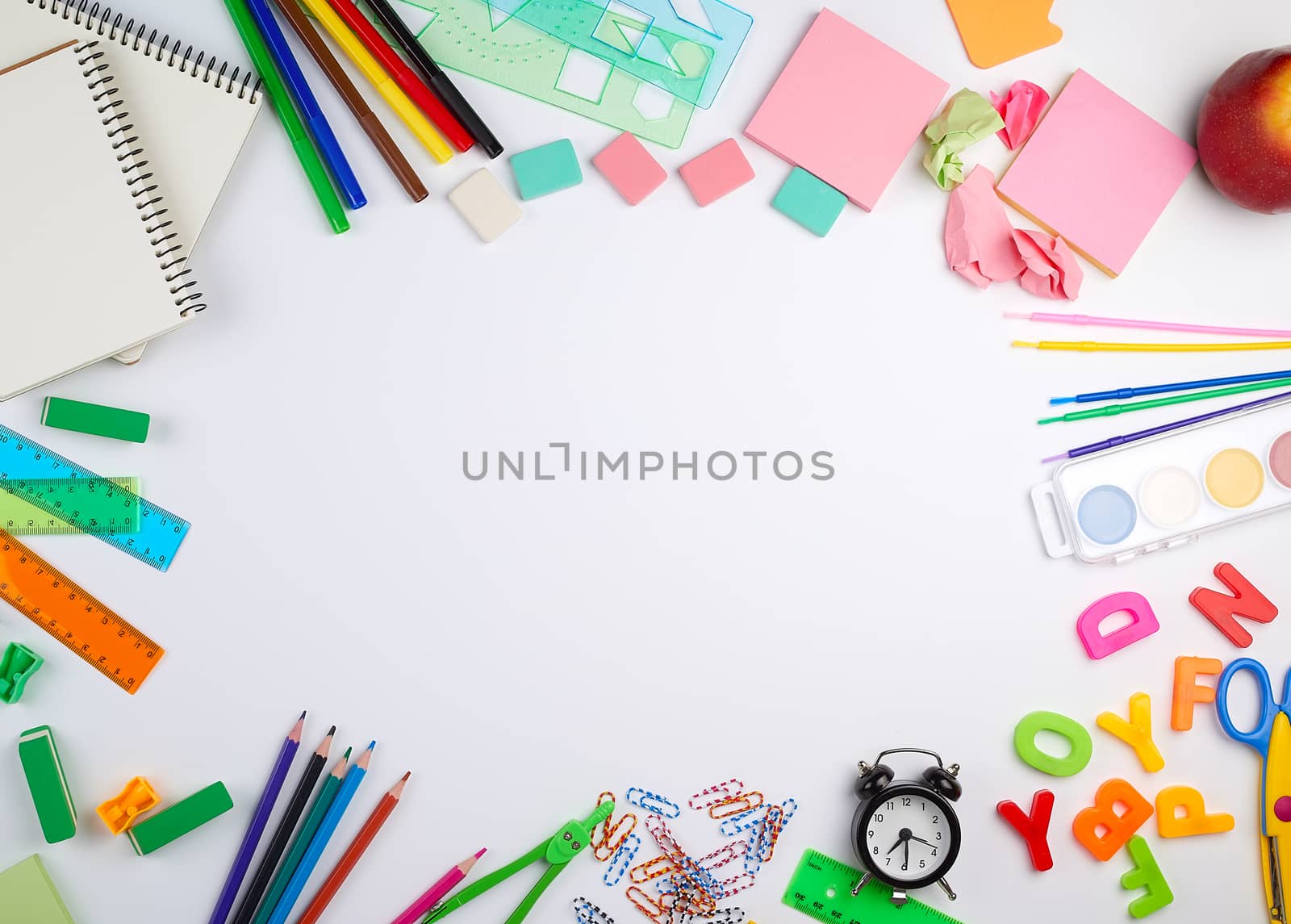 school supplies: multicolored wooden pencils, paper stickers, paper clips, pencil sharpener, copy space
