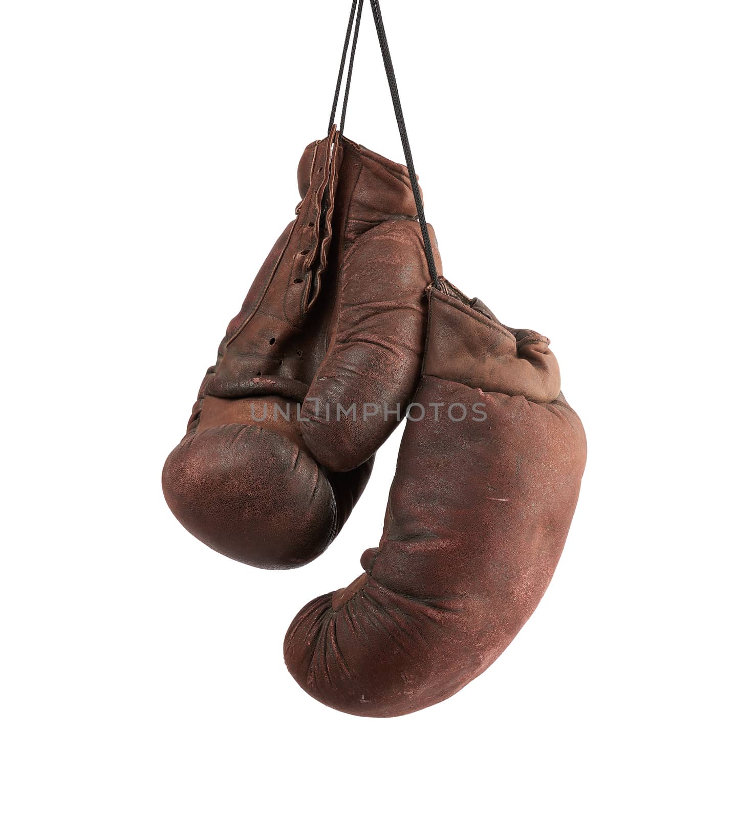 pair of very old vintage brown leather boxing gloves hanging on a black rope, object isolated