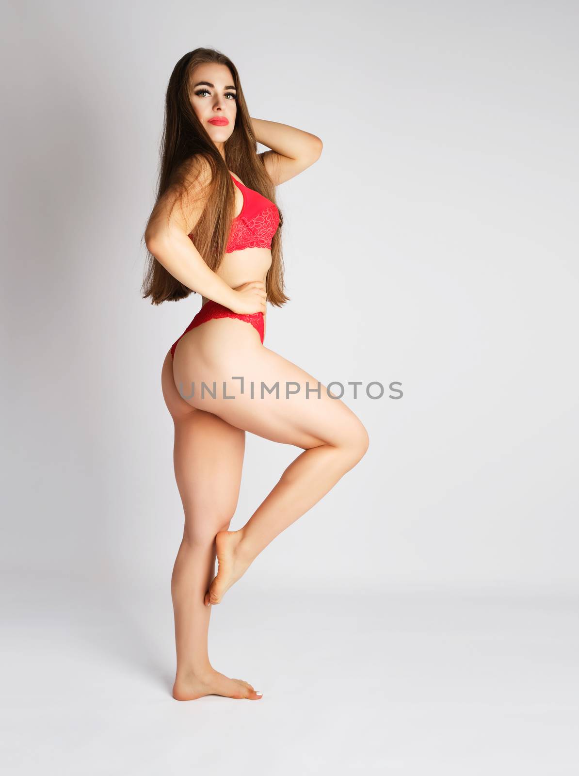 beautiful girl with a slim figure dressed with red lace lingerie by ndanko