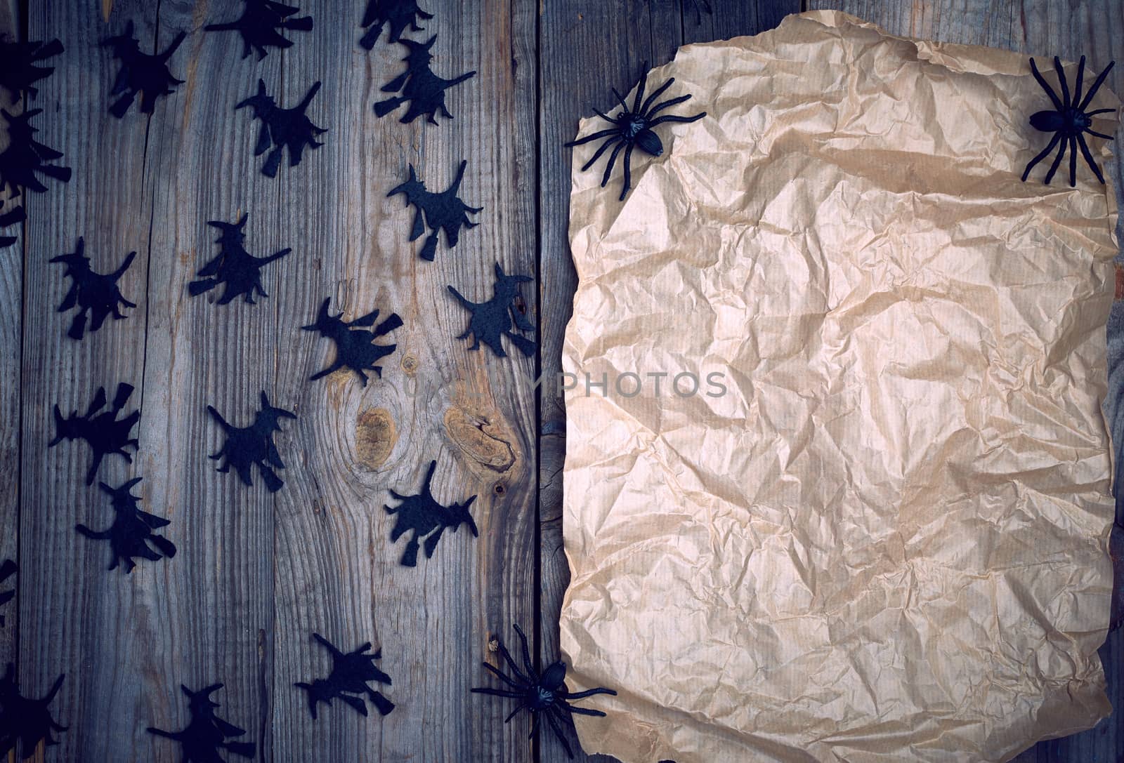brown paper and black spiders, empty place for writing invitation to the holiday Halloween