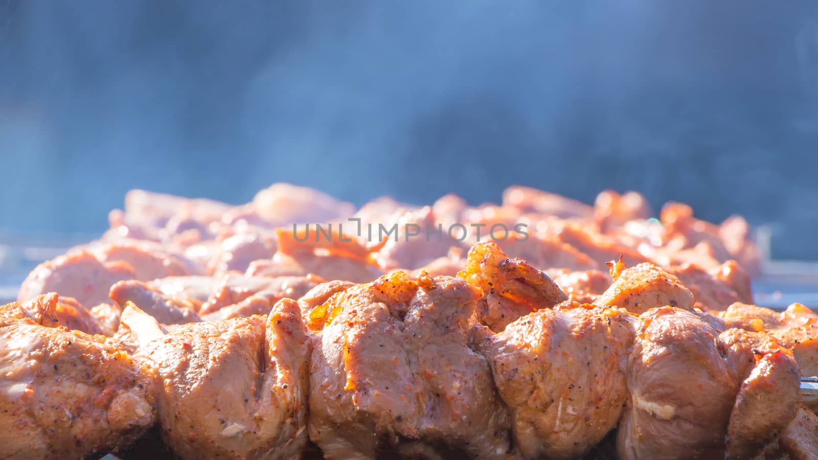 We fry shish kebabs, barbecue, BBQ in the backyard in the summer on a weekend. The chef prepares meat in a cafe or restaurant. Fresh raw and fried pork, beef and lamb meat on a skewer.