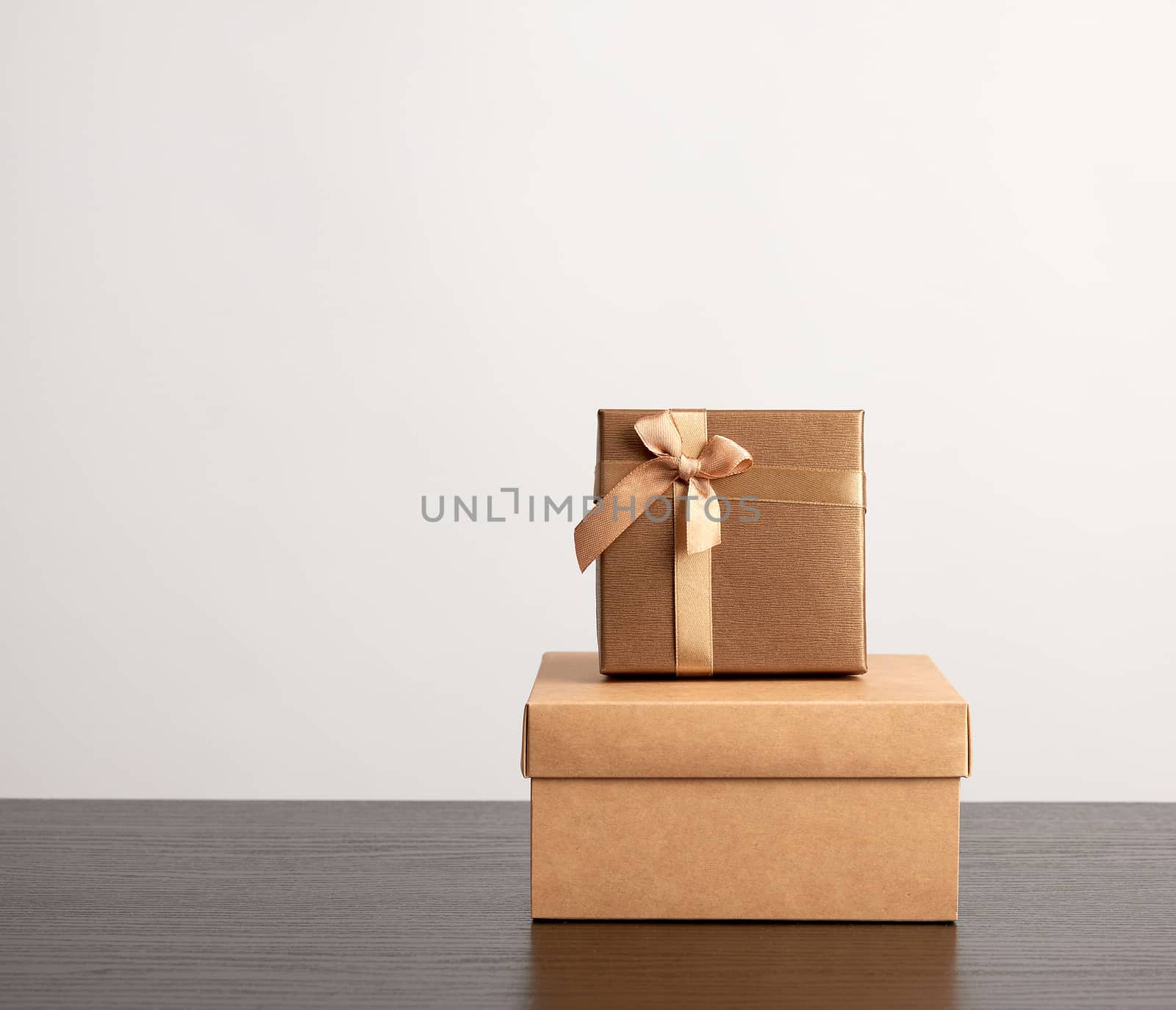 stack of various cardboard boxes for gifts on a black table, white background
