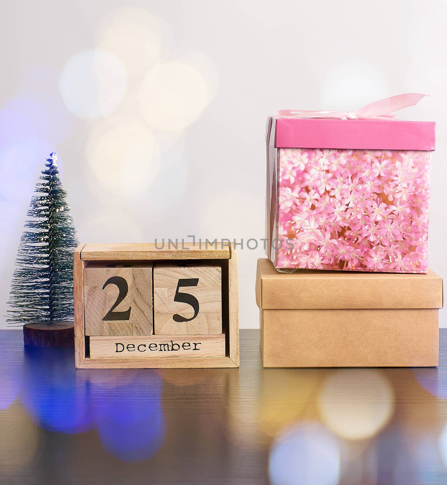 wooden retro calendar from blocks, Christmas decorative tree and cardboard boxes with gifts, white background