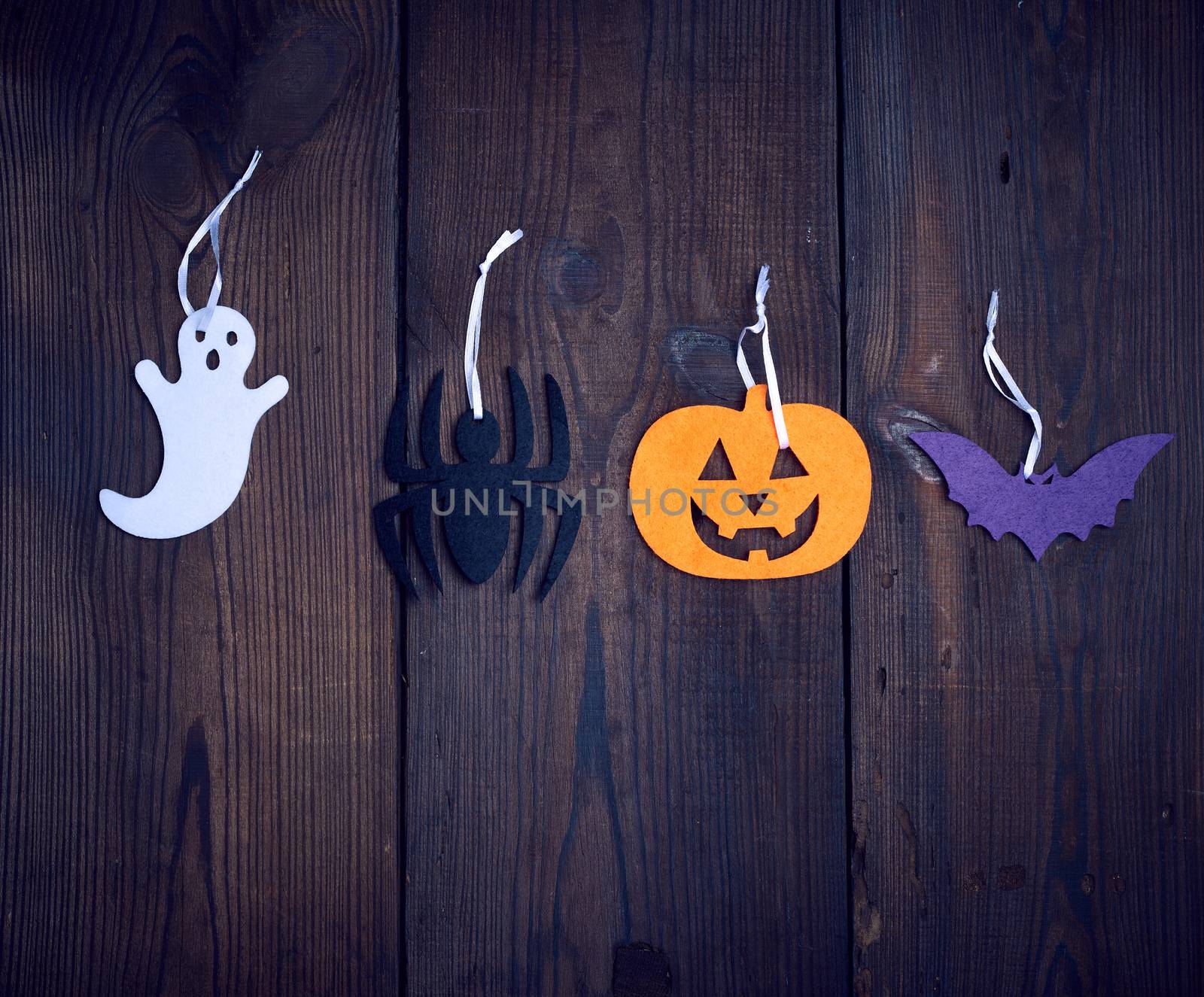 colorful felt figures on a wooden background, festive backdrop for Halloween