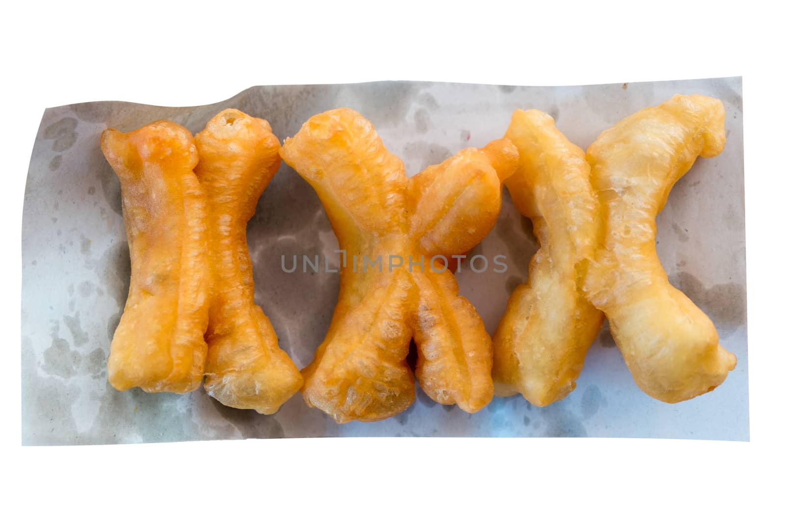Deep-fried dough stick on the oil blotting paper with a white background
