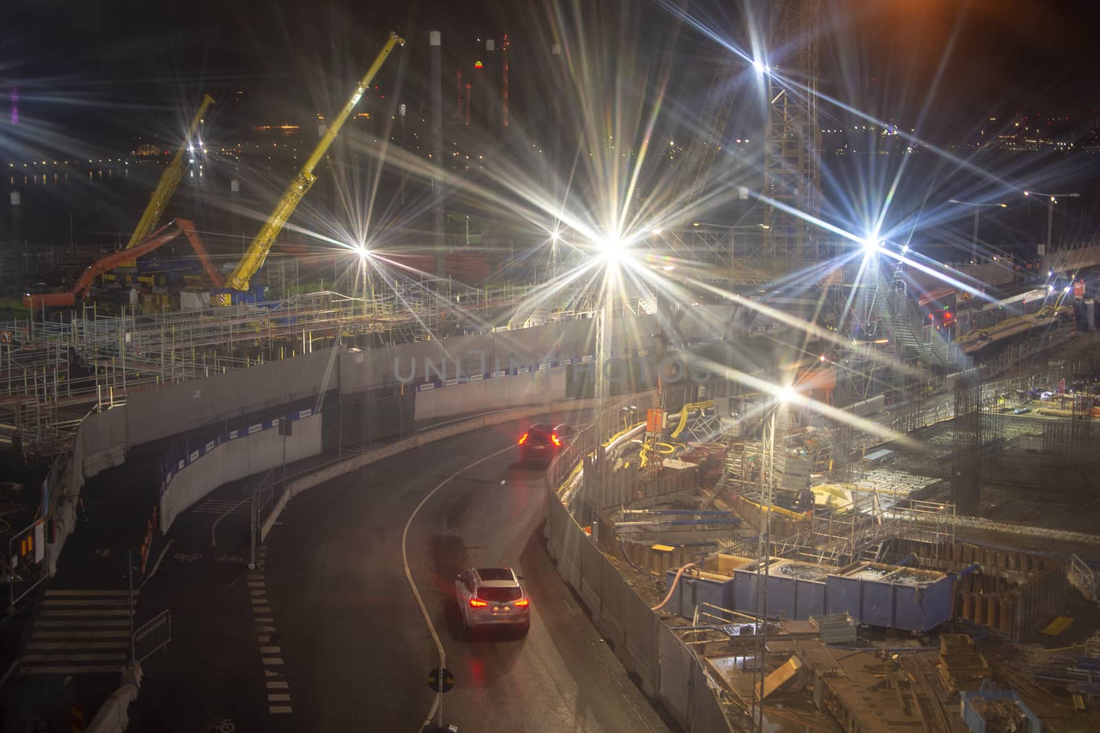 Motion blur with bright light over large construction site.