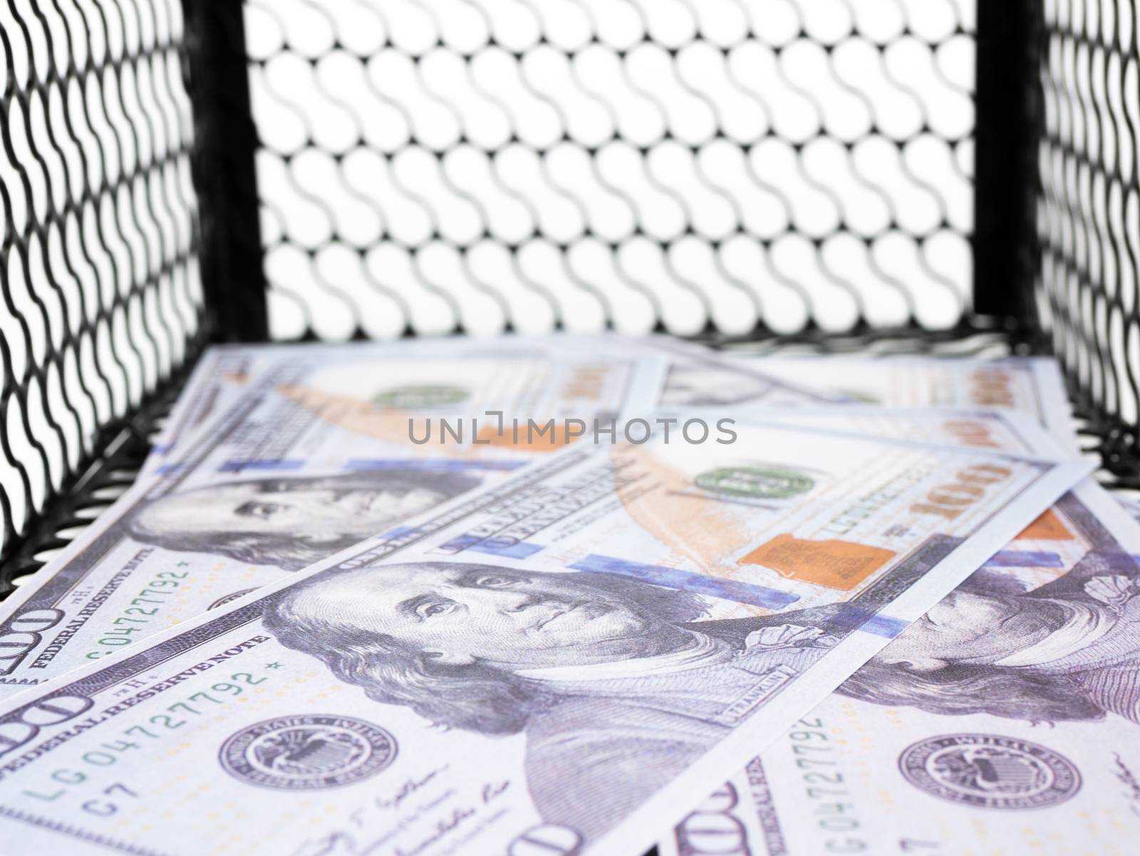 Dollars money in a mouse trap on white background