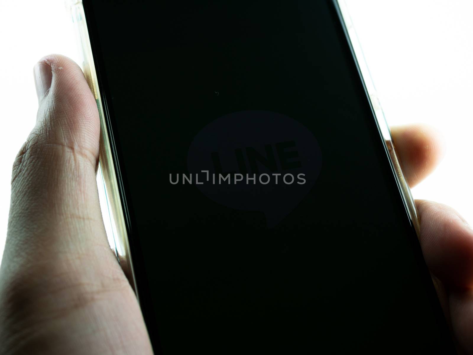 Close-up hand holding phone black screen.