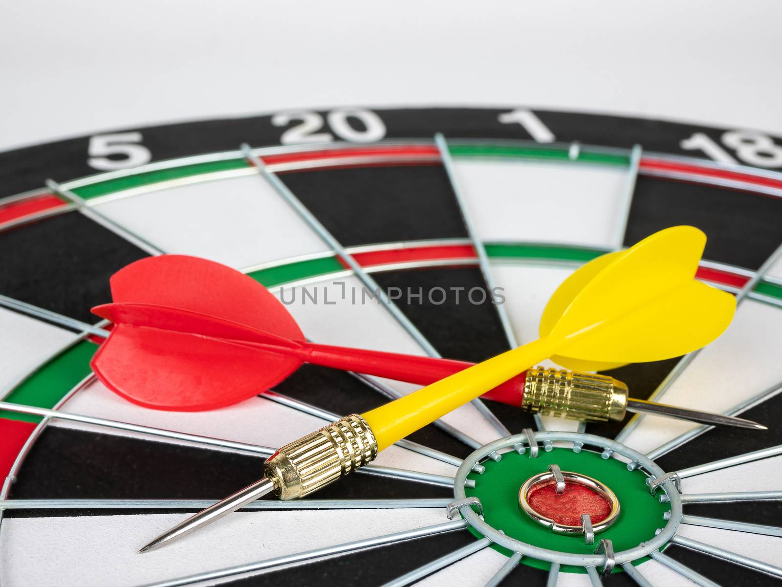 Red and yellow Dart arrows and dartboard.