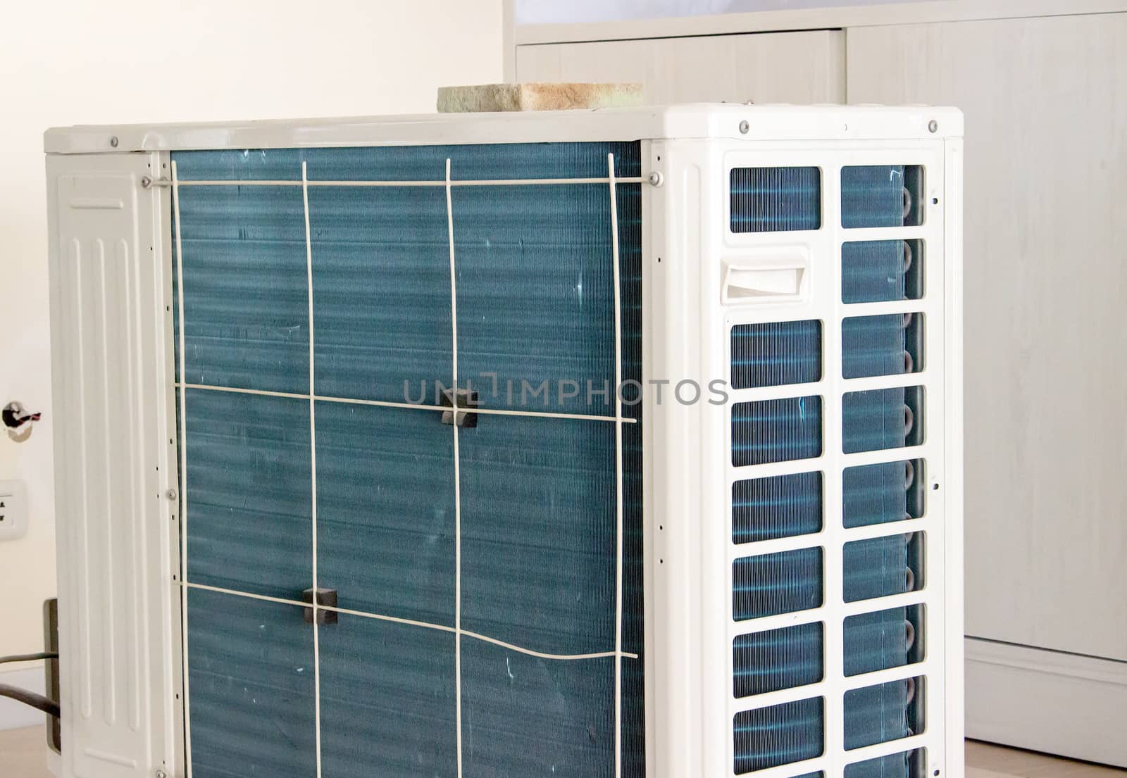Residential air conditioner condenser unit inside a house