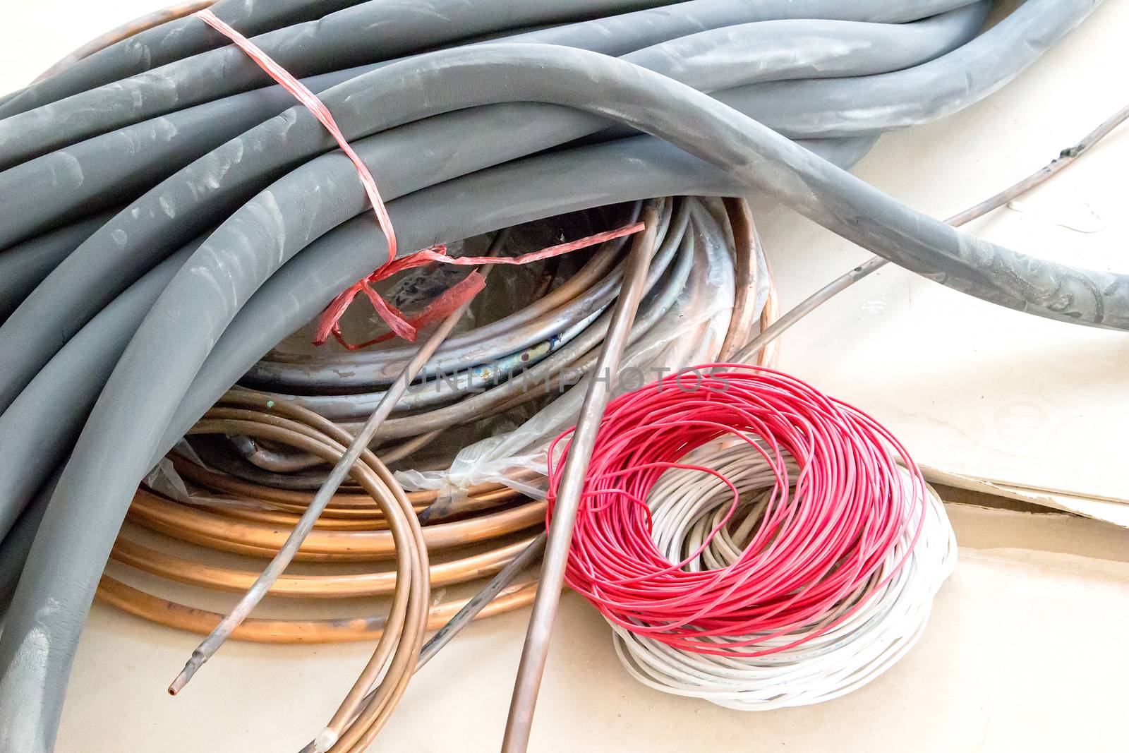 Rubber tubes and wires lay on the cement floor.