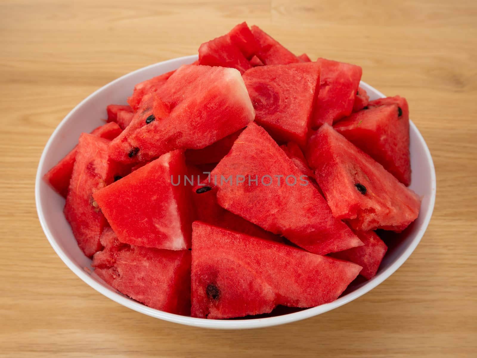 Cube slices of a ripe watermelon on a plate. Selective focus.