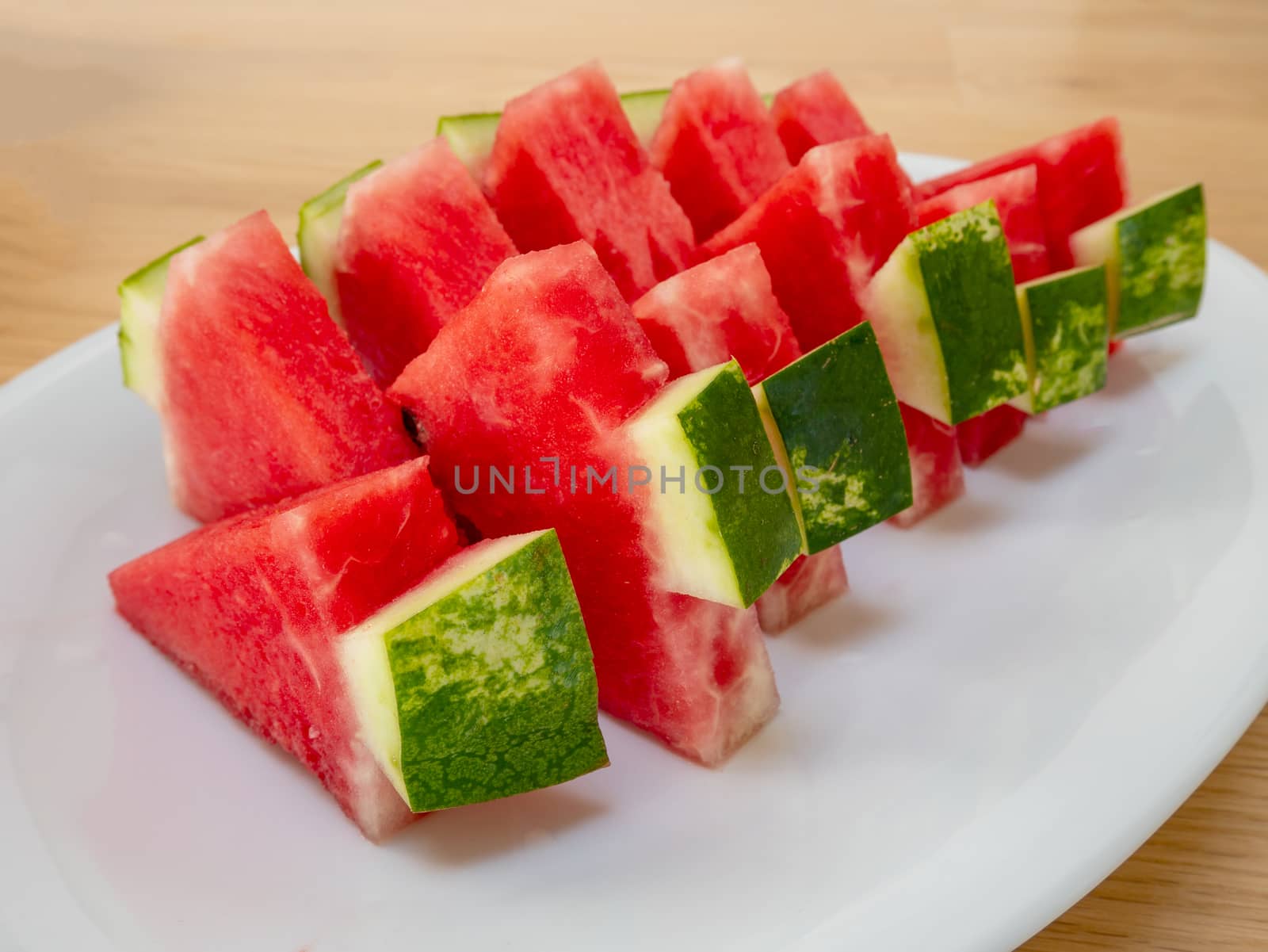 Slices of a ripe watermelon on a plate, Selective focus. by Amankris