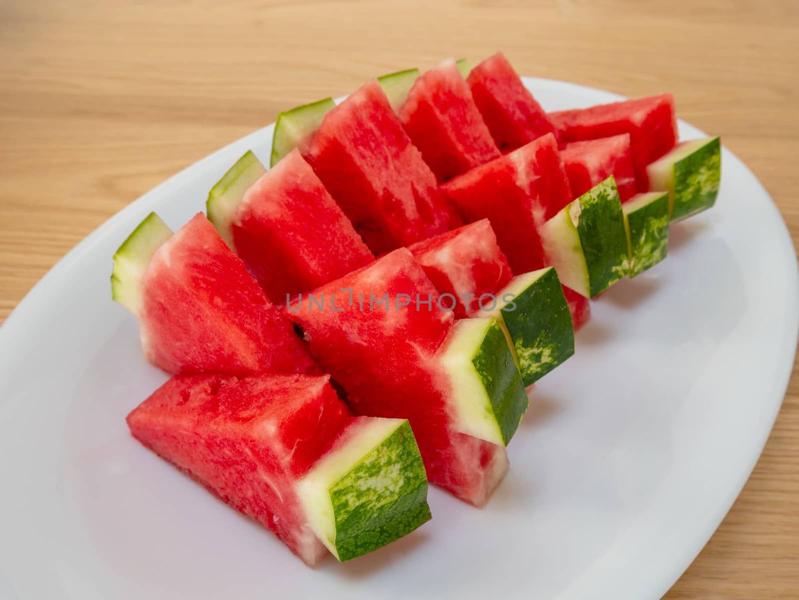 Slices of a ripe watermelon on a plate by Amankris
