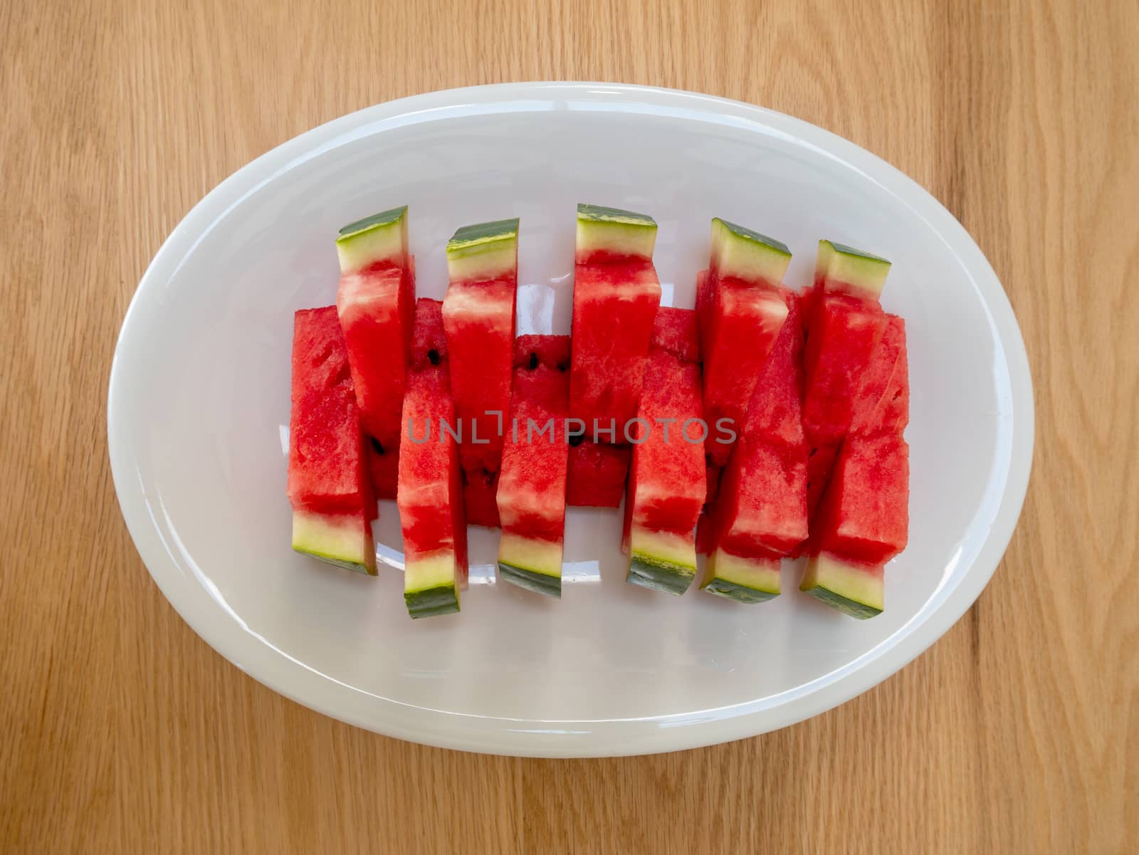 Slices of a ripe watermelon on a plate, Selective focus. by Amankris