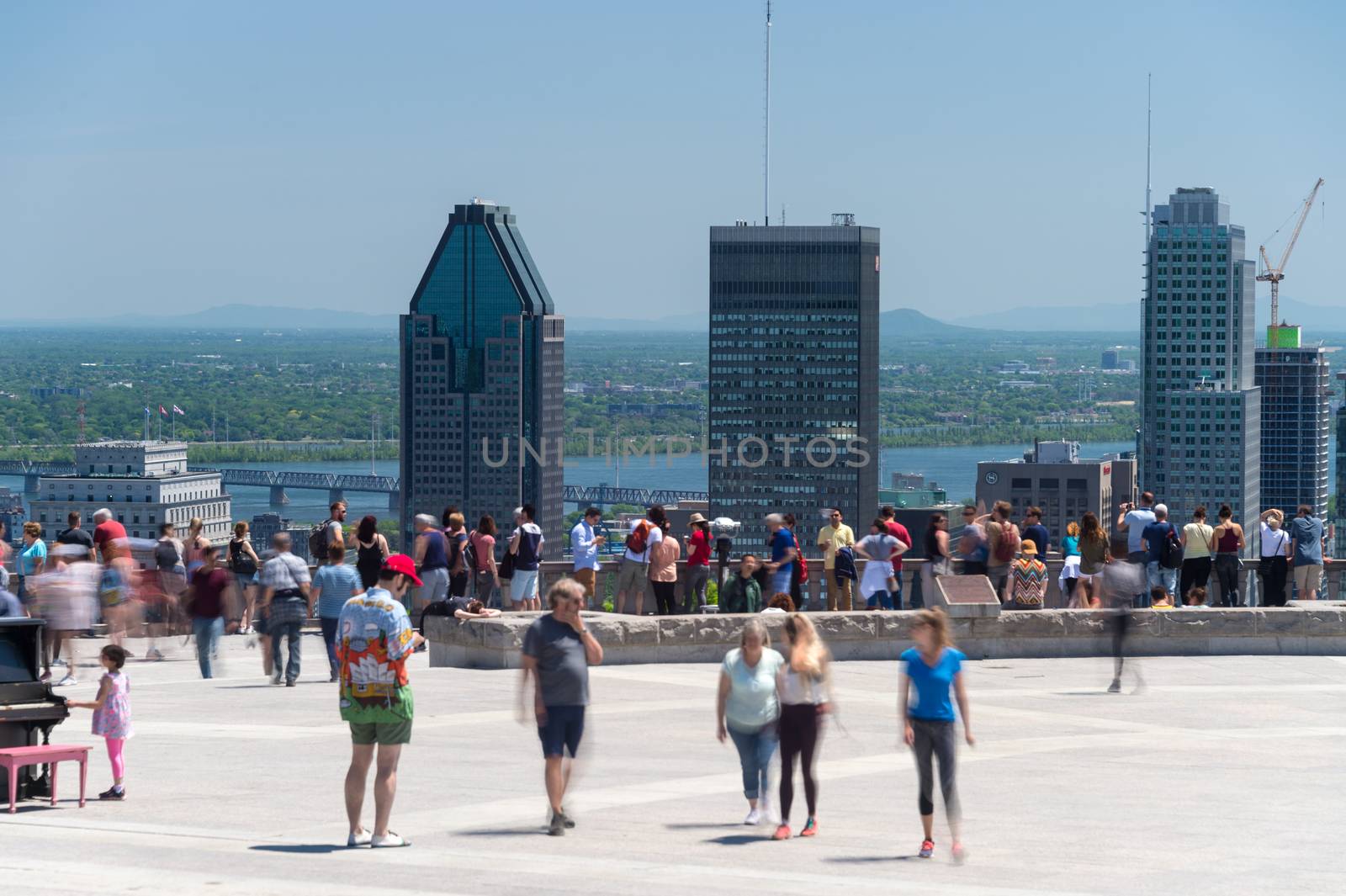 People looking at Montreal Skyline from Mont Royal lookout by mbruxelle