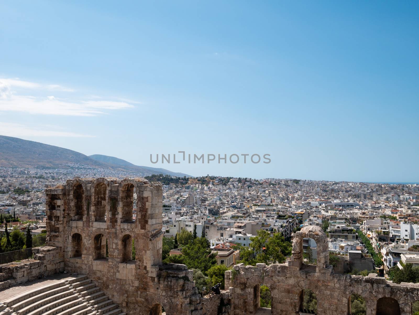 Odeon of Herodes Atticus at the Acropolis with Athens city in Gr by Amankris