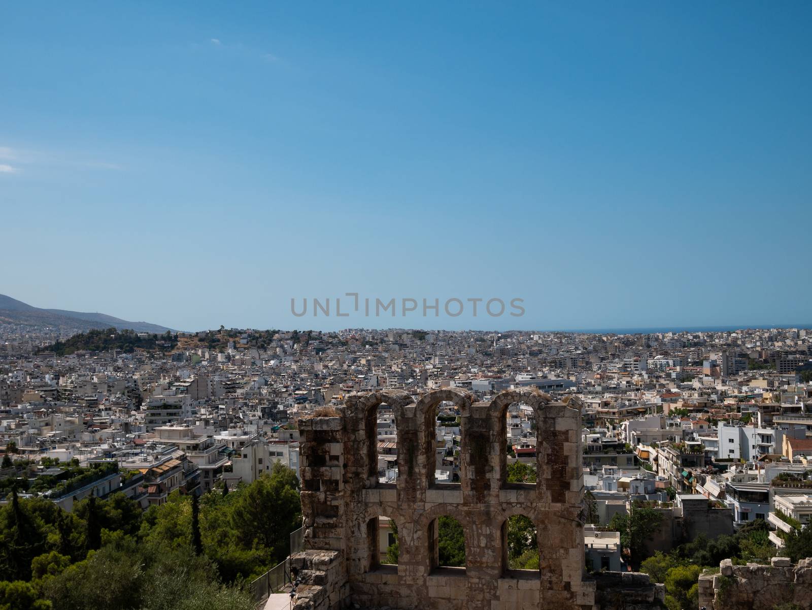 Odeon of Herodes Atticus at the Acropolis with Athens city in Gr by Amankris