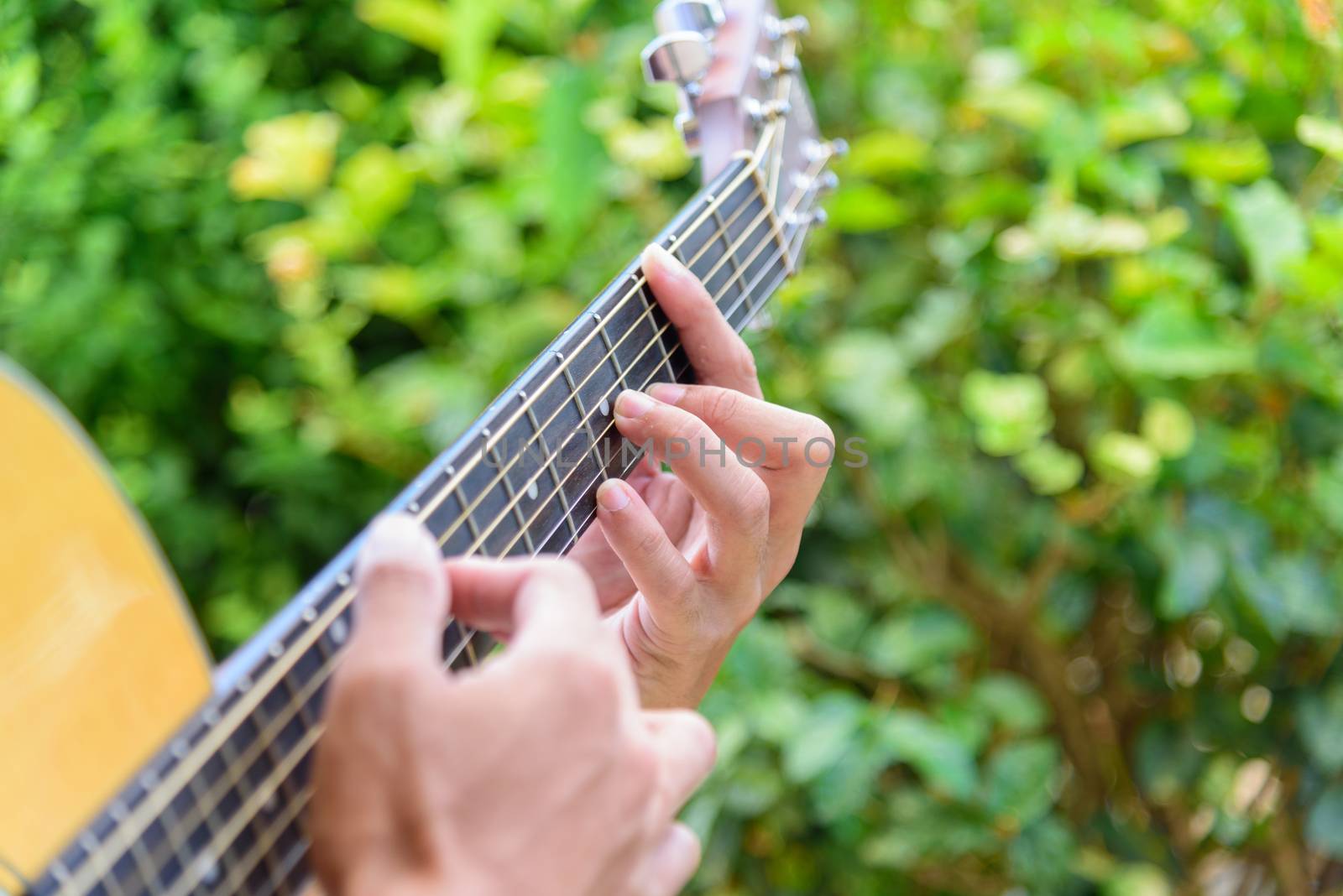 The guitarist tapping technic to fingerboard of guitar