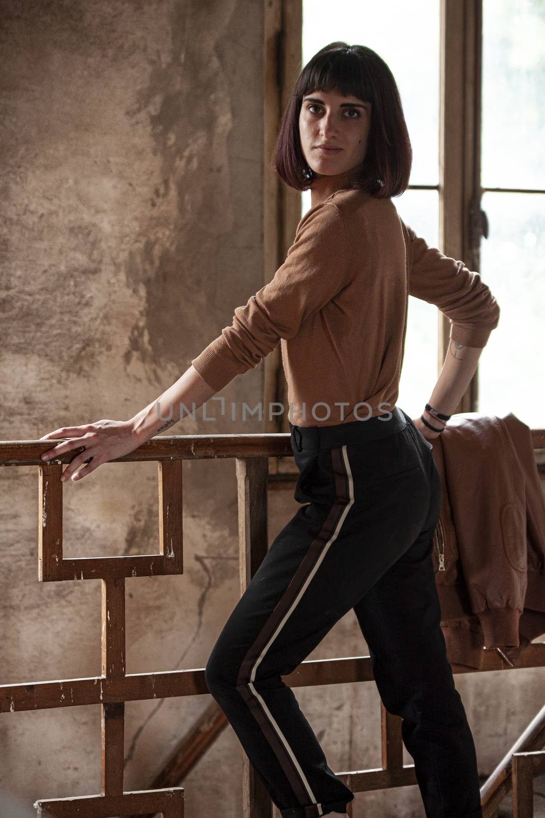 Portrait of a brunette girl in abandoned House, image in low light