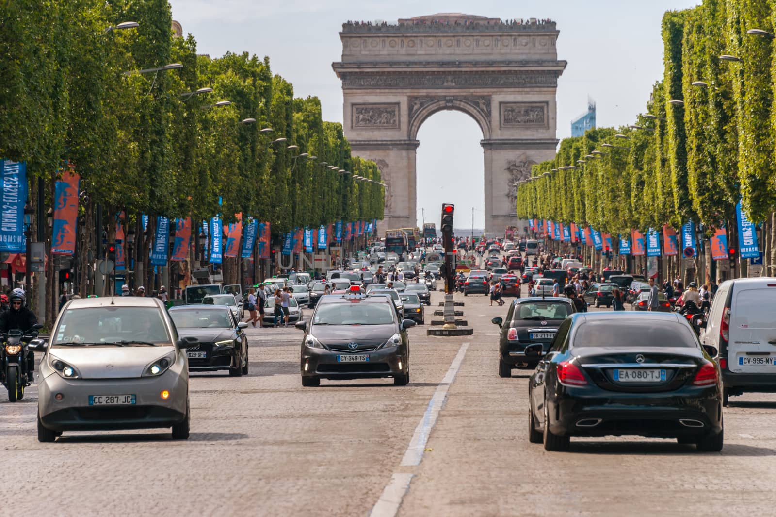 Paris, France - 23 June 2018: Traffic down the Champs Elysees Avenue and the Arc de Triomphe.