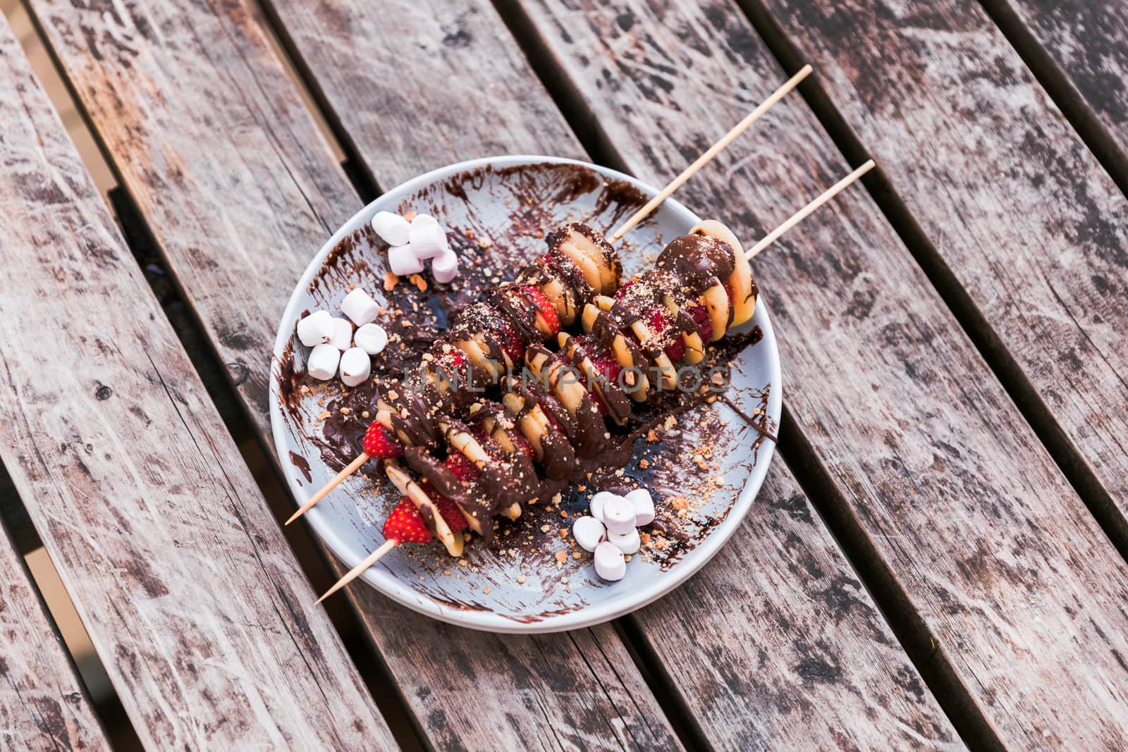 Homemade mini crepe and strawberry skewers on table by camerarules