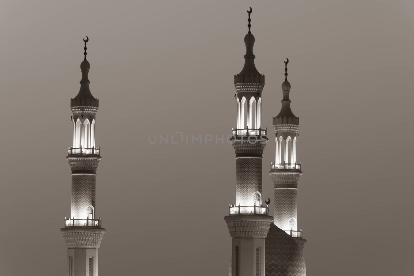 Islamic mosque spires in black and white echos prayer calls at night. Muslim, ramadan, religion concepts.