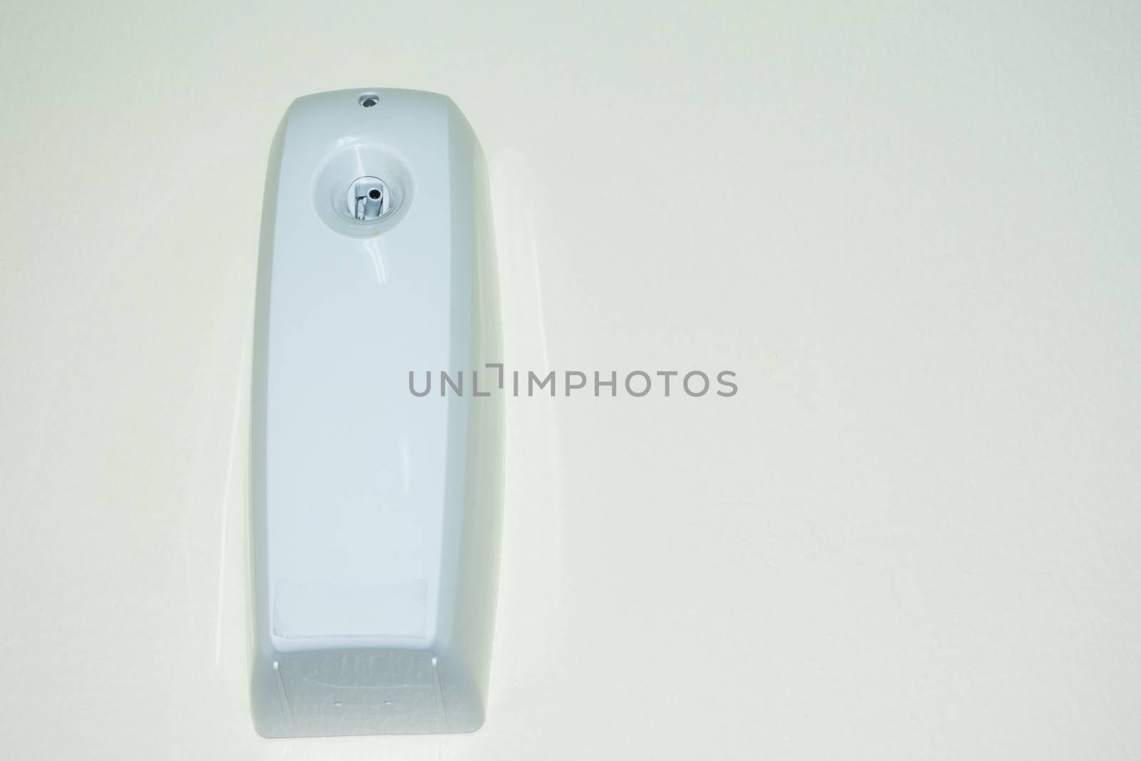 aromatic odor spray dispenser on the wall on a timer to add fragrance in the house or office