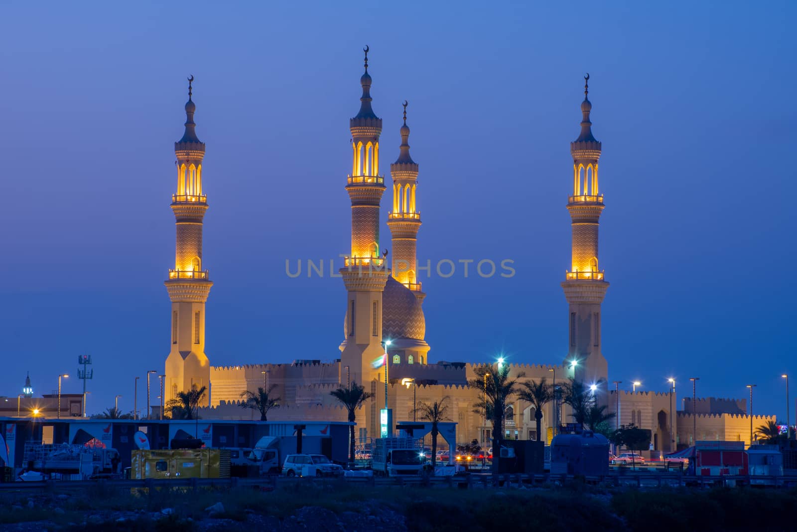Sheikh's Zayed's Mosque glowing colors in Ras al Khaimah, UAE at night echos prayer call along the  Corniche.