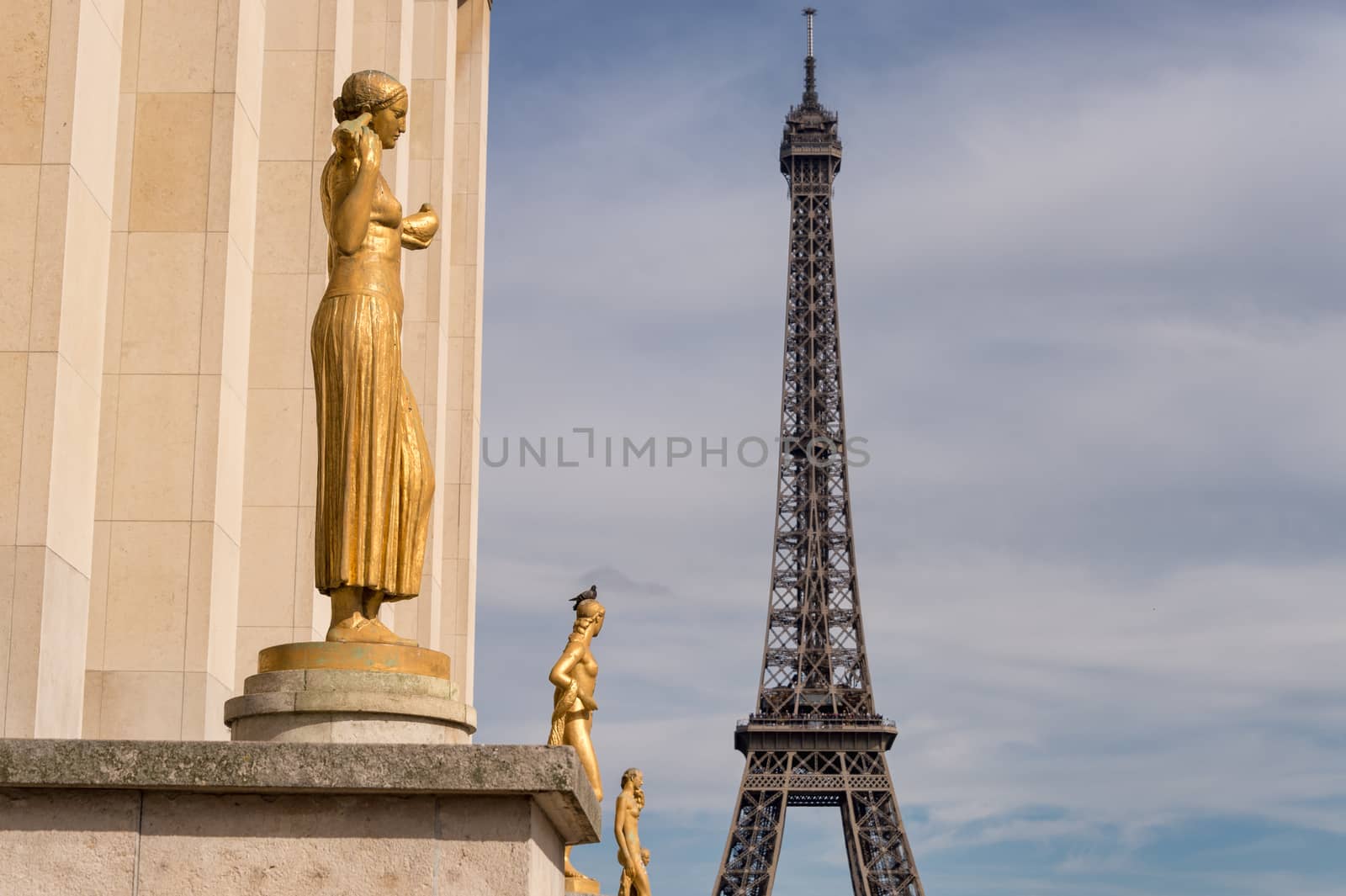 Paris, France - 23 June 2018: Eiffel Tower from Trocadero with golden statues in the foreground