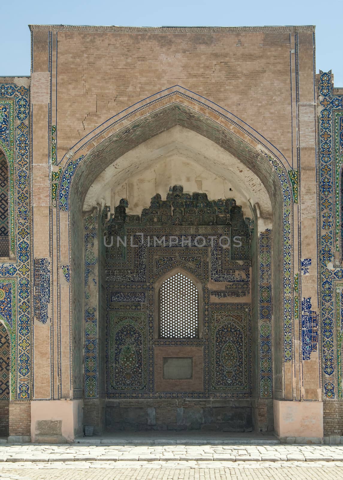 Arch and door with peeling traditional ancient Asian ornament. the details of the architecture of medieval Central Asia