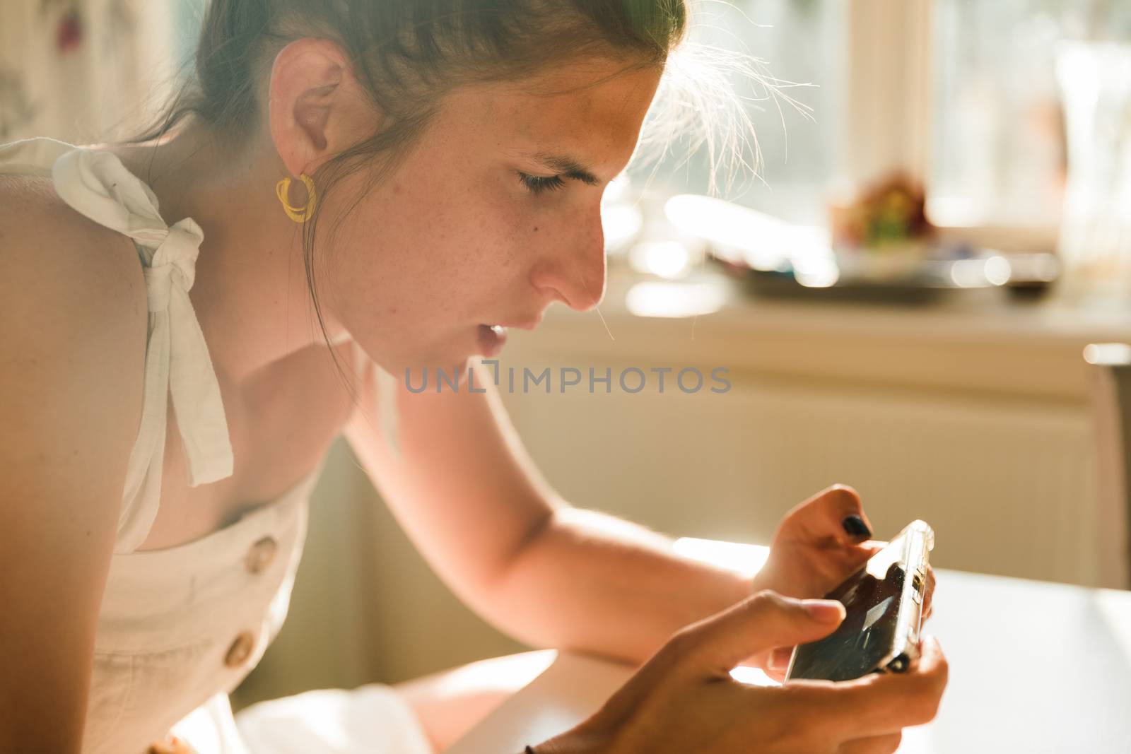 Young woman playing online games on a mobile phone