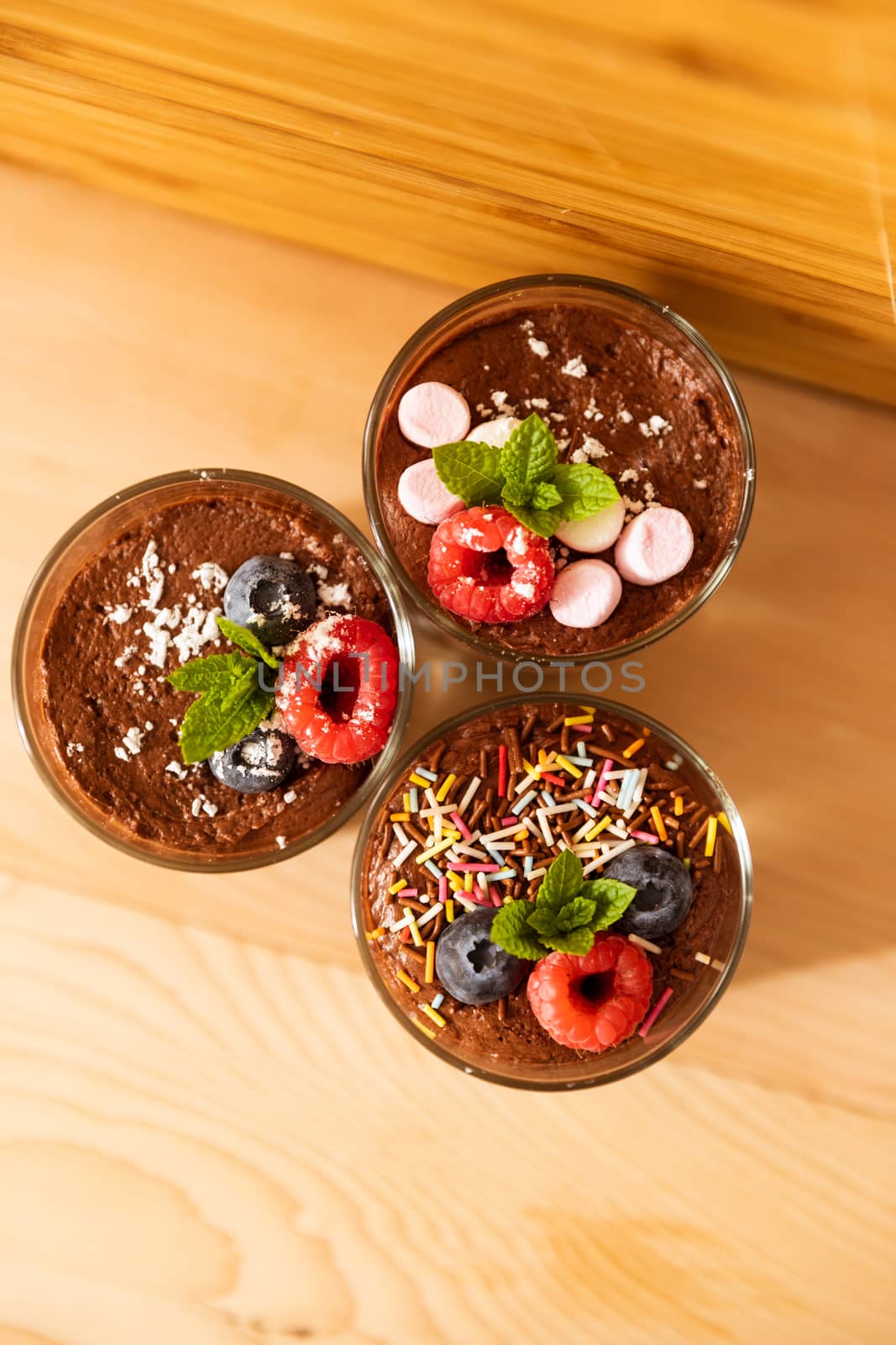 Top view group shot of glasses filled with delicious mousse chocolate by camerarules