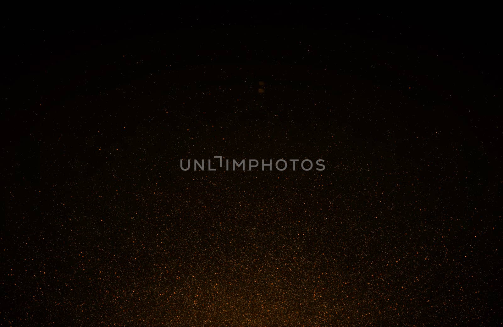 Abstract retro 1920 style vintage background of flickering gold tone particles and light flare