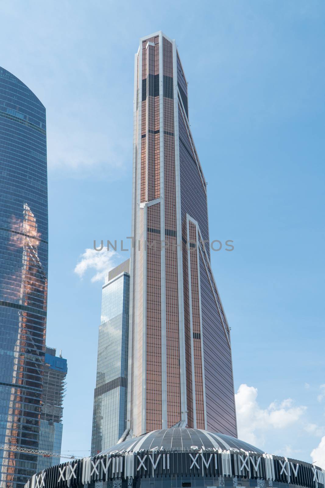 High rise buildings of the business center of Moscow. District Moscow-city against the day sky with clouds