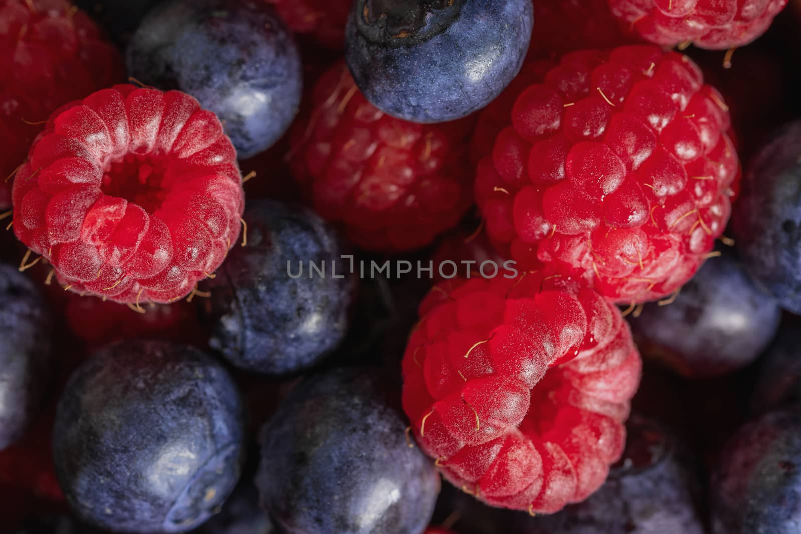 Pile of blueberries and raspberries. Macro shot. A filled frame.