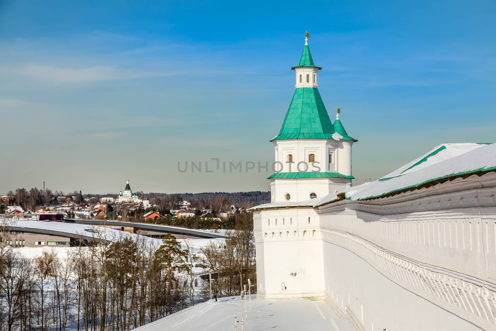 Fortified walls and white towers with green roof, winter landscape, New Jerusalem Monastery , Istra, Moscow region, Russia